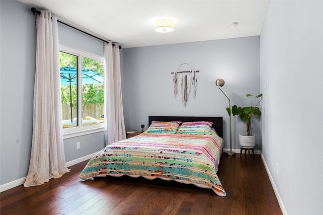 Bedroom with wood finished floors and baseboards | Image 9