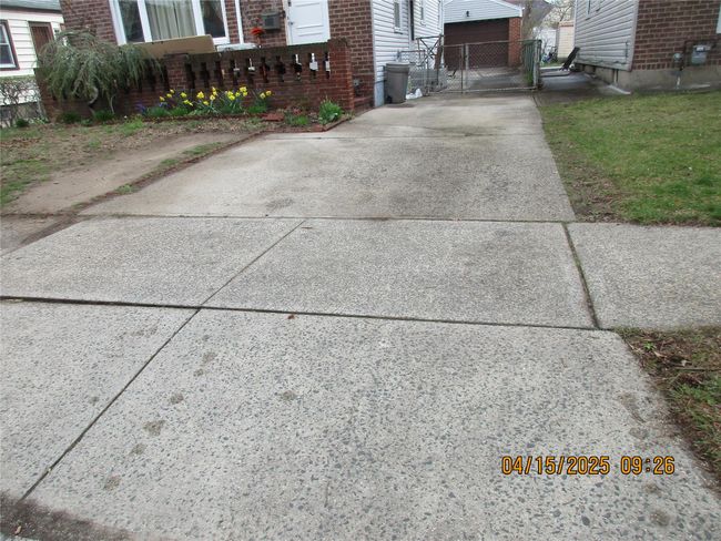 Details with concrete driveway, brick siding, and a gate | Image 24