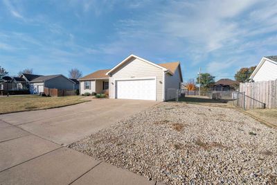 Ranch-style house featuring a front yard and a garage | Image 2