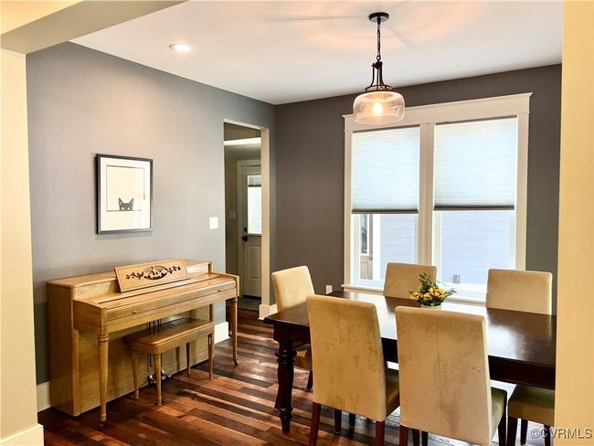 Dining space with reclaimed oak wood finished floors and recessed lighting | Image 10