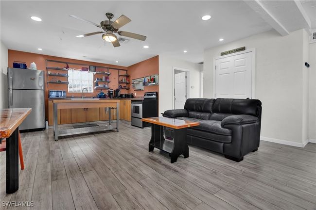 Living area with light flooring, baseboards, visible vents, recessed lighting, and a ceiling fan | Image 11