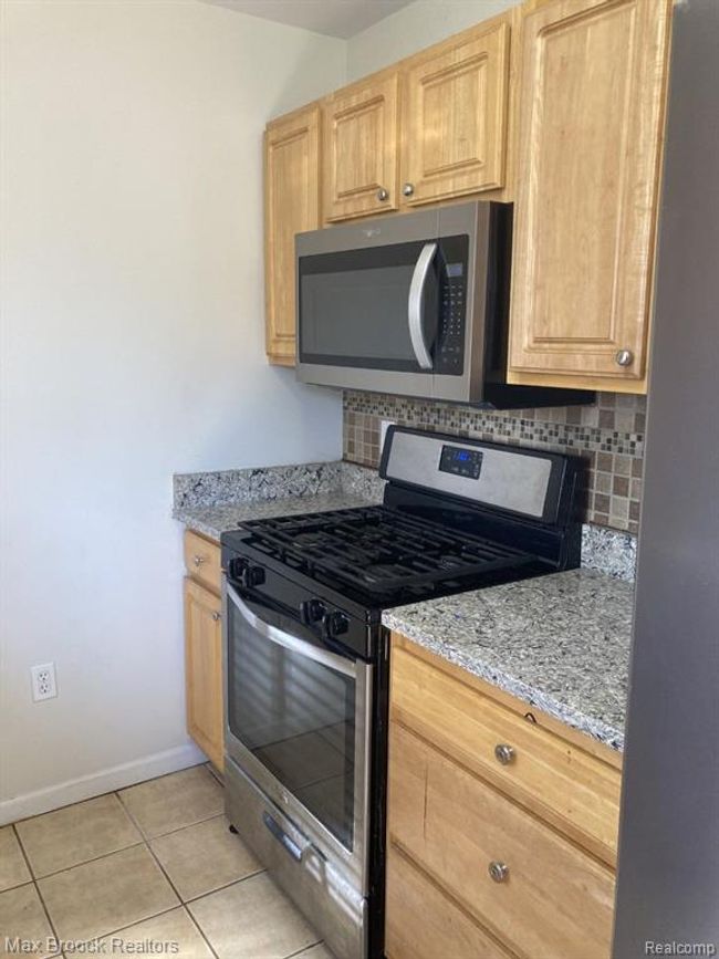 Kitchen with gas range & oak cabinets | Image 6