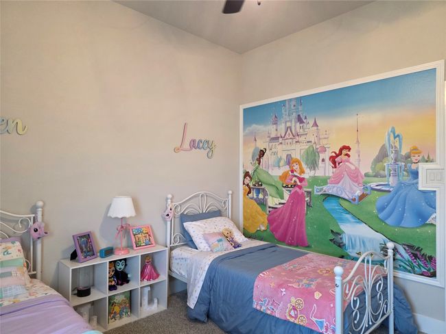 Carpeted bedroom featuring ceiling fan | Image 30