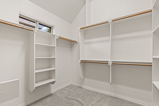Spacious closet featuring carpet flooring and vaulted ceiling | Image 22