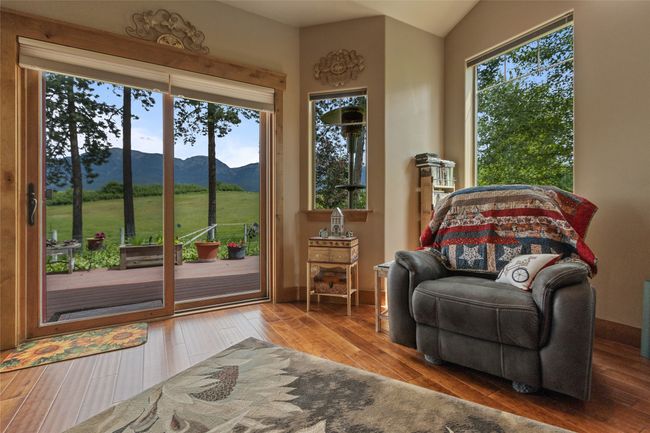 Living area with a mountain view, wood finished floors, and lofted ceiling | Image 33