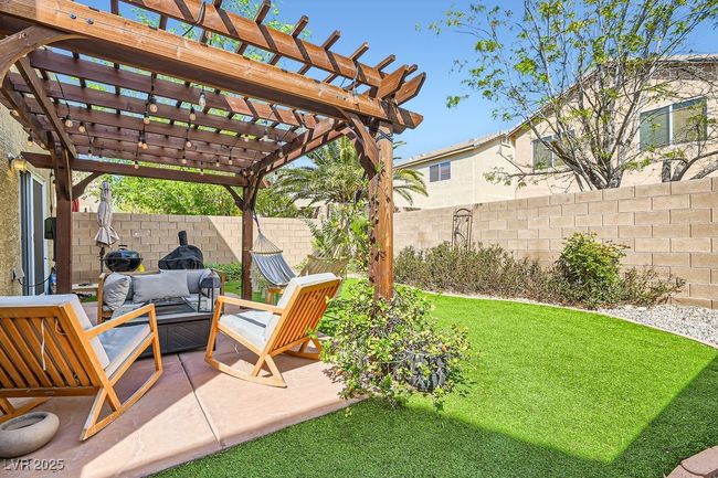 View of yard featuring a fenced backyard, an outdoor hangout area, a patio, and a pergola | Image 20