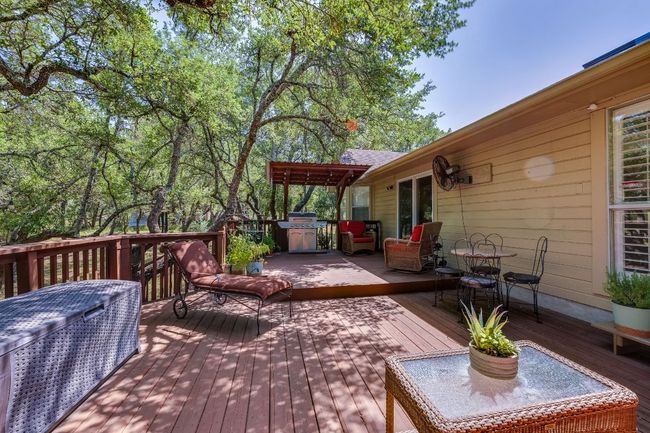 Deck with outdoor dining space and a grill | Image 29