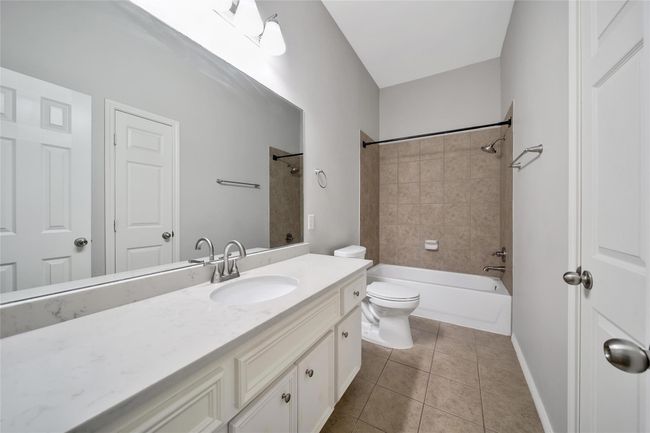The secondary bath is centrally located and easy to share with an oversized quartz vanity and amazing storage including the linen closet and medicine cabinet. | Image 23