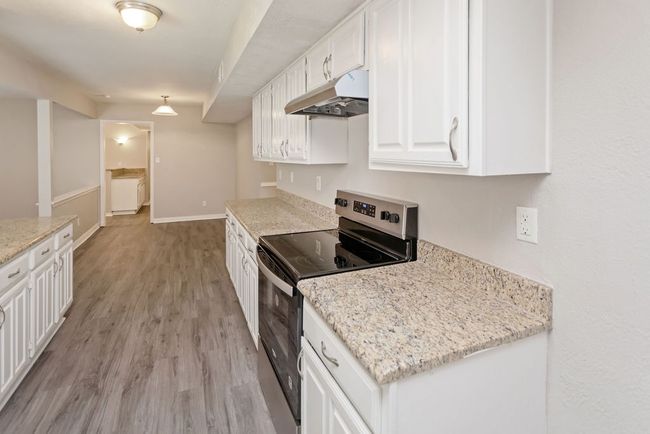 Kitchen with dishwasher, white cabinetry, and healthy amount of natural light | Image 8