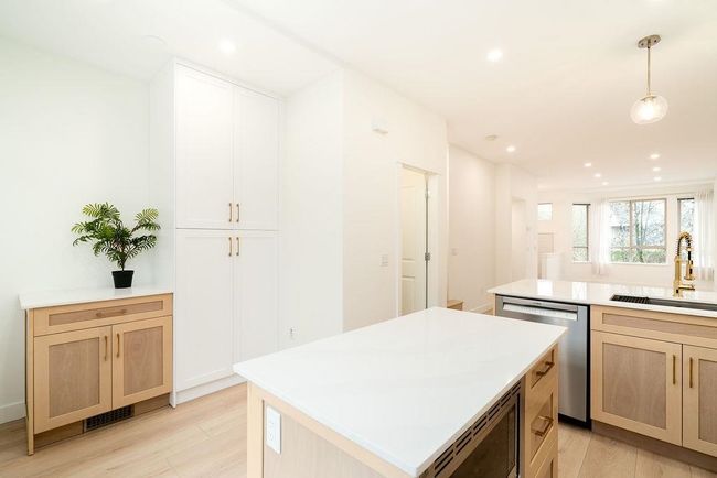 Kitchen featuring a sink, light brown cabinets, appliances with stainless steel finishes, and light wood finished floors | Image 6