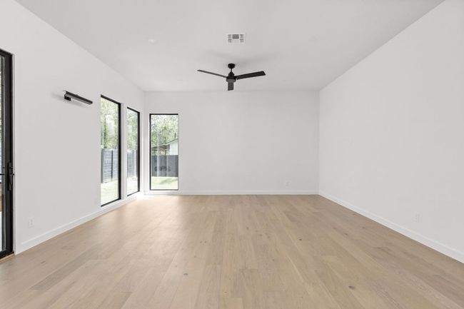 Empty room featuring ceiling fan and light wood finished floors | Image 12