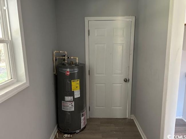 Utility room featuring electric water heater | Image 18
