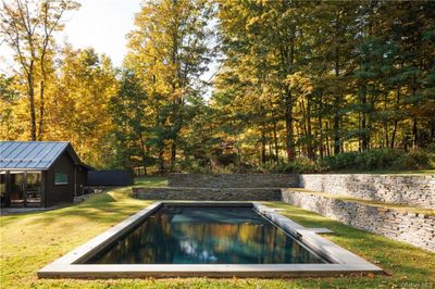 View of pool with an outdoor structure and a yard | Image 3