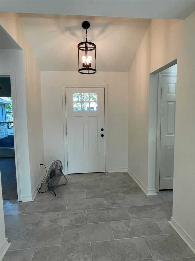 Entrance foyer with baseboards and a chandelier | Image 5