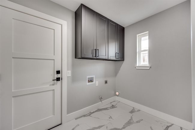 Washroom with hookup for an electric dryer, cabinet space, hookup for a washing machine, gas dryer hookup, and marble finish floors | Image 35
