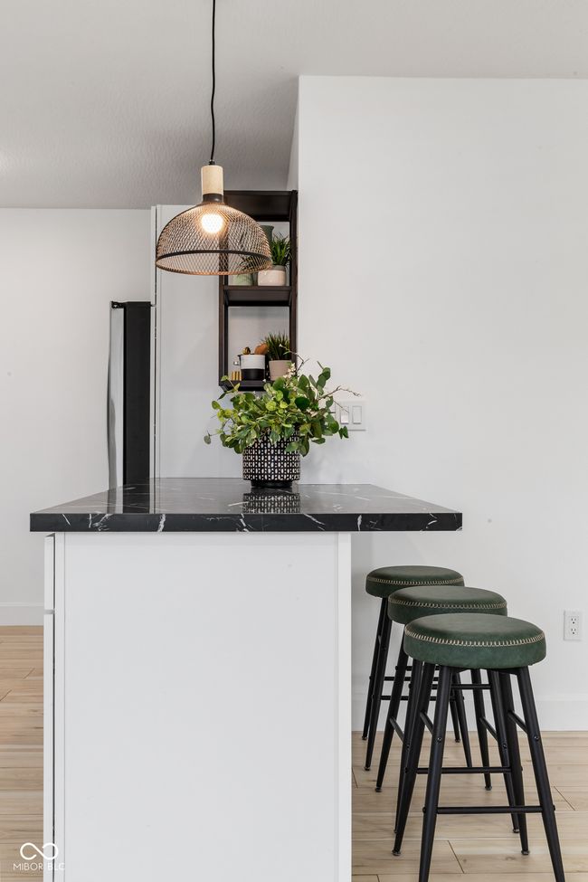 kitchen with dark countertops, freestanding refrigerator, and light wood-style floors | Image 29