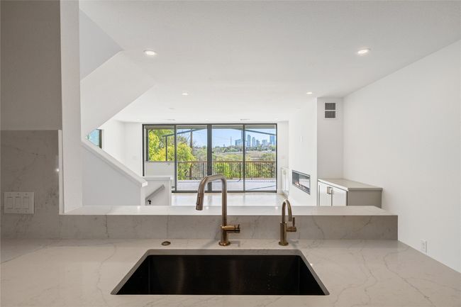 Looking in to the living room from the​​‌​​​​‌​​‌‌​‌‌​​​‌‌​​‌‌​‌​​​​​‌ kitchen | Image 26