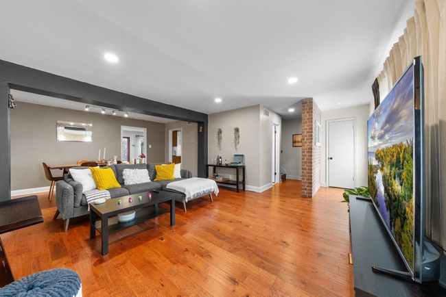 Living room with wood-style flooring, recessed lights and plenty of natural light | Image 5