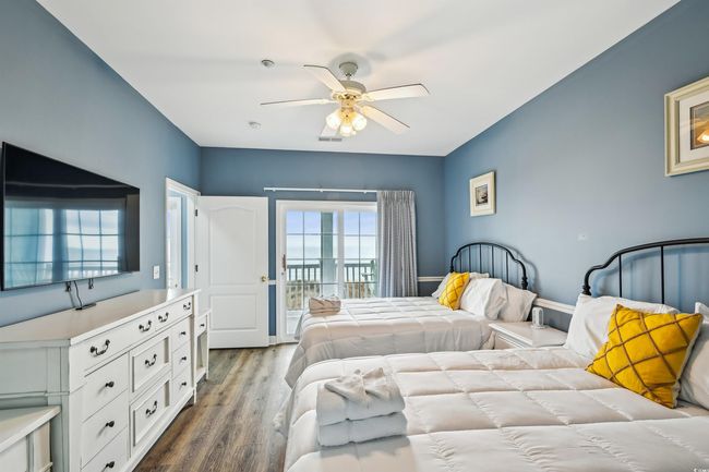Bedroom with access to outside, dark wood-style floors, and a ceiling fan | Image 14