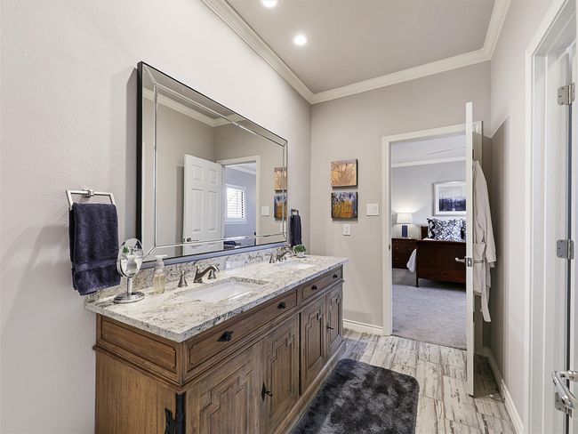 Full bath featuring ornamental molding, wood finished floors, ensuite bathroom, double vanity, and recessed lighting | Image 26