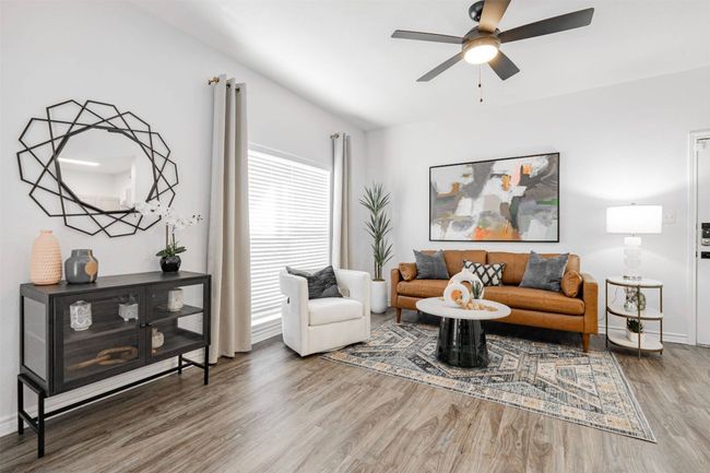 Living room featuring hardwood / wood-style flooring and ceiling fan | Image 10