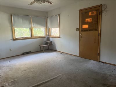 Carpeted spare room with ceiling fan | Image 2