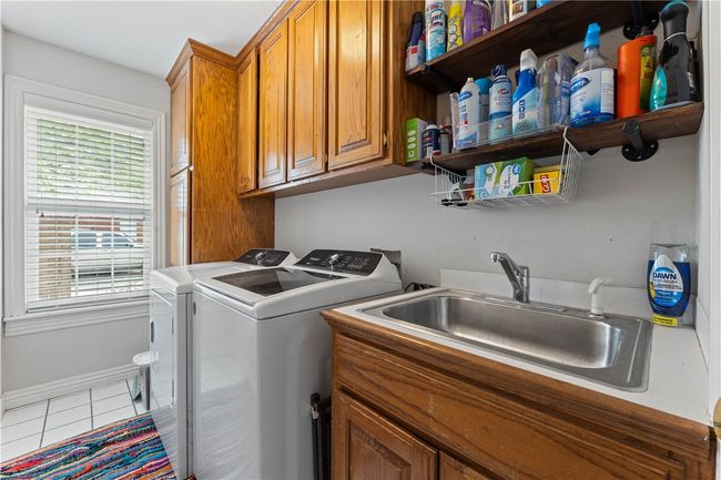 Laundry room with ample storage | Image 26