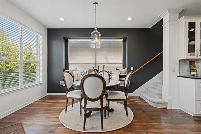 Dining room with recessed lighting, dark wood-type flooring, stairway, and baseboards | Image 7