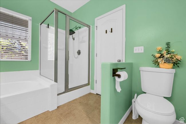 Full bath featuring toilet, a stall shower, and a bath | Image 20