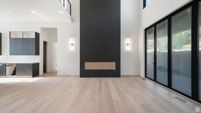 Progress pictures, 7/11/25: Unfurnished living room with healthy amount of natural light, a high ceiling, and light wood-style floors | Image 6