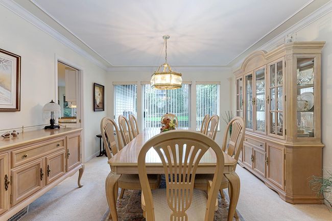 Dining space with light carpet and ornamental molding | Image 8