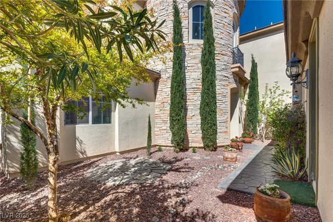 View of property exterior featuring stucco siding and stone siding | Image 8