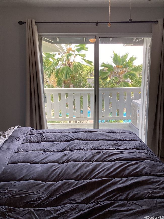 Primary bedroom with view of the lanai and pool area | Image 10