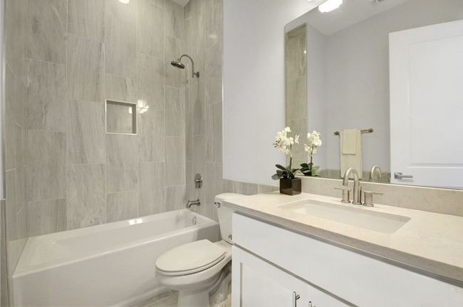Bathroom featuring bathing tub / shower combination, vanity, and toilet | Image 18