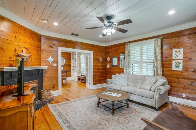 Living area featuring crown molding, ceiling fan, light wood finished floors, wooden walls, and recessed​​‌​​​​‌​​‌‌​‌‌​​​‌‌​​‌‌​‌​​​​​‌ lighting | Image 10