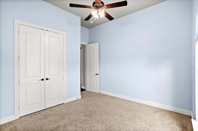 Unfurnished bedroom featuring carpet floors, a closet, baseboards, and a ceiling fan | Image 24