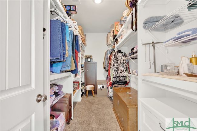 Large walk-in closet with custom wood shelving | Image 23