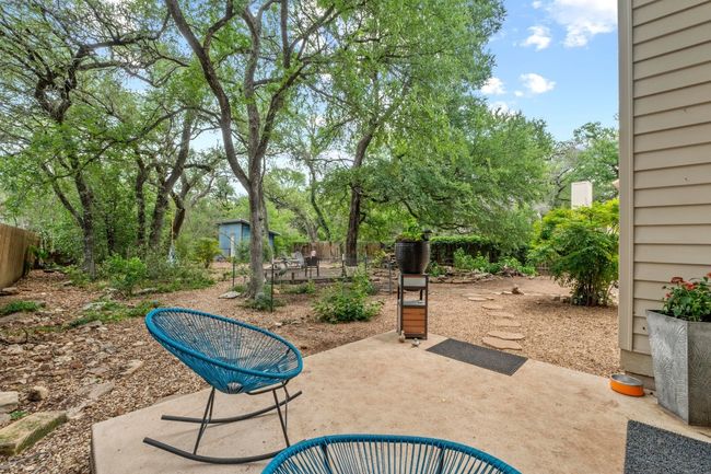 The patio is ready for backyard dinners, weekend hangouts, or just a moment of stillness under the trees | Image 24