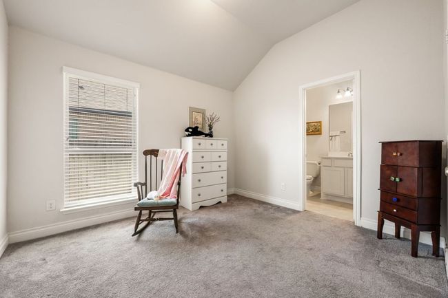 Sitting room with baseboards, lofted ceiling, and light colored carpet | Image 22