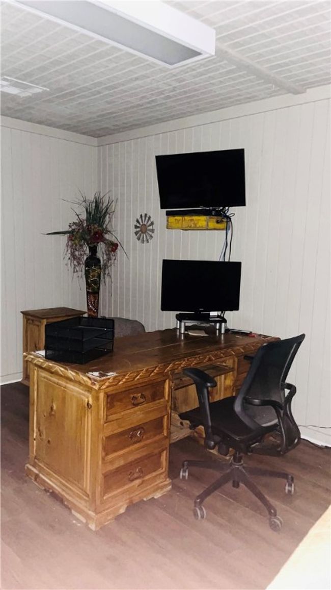 Home office with hardwood / wood-style floors and wood walls | Image 5