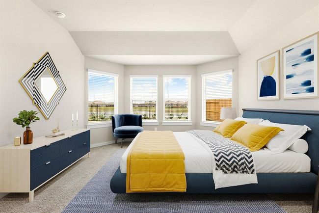 What a wonderful place to come home to, this stunning primary suite greets you with plush carpet floors, a warm neutral paint, raised ceilings, lovely windows with blinds allowing in natural light brightening up this spacious primary bedroom, with extra space for a seating area. | Image 9