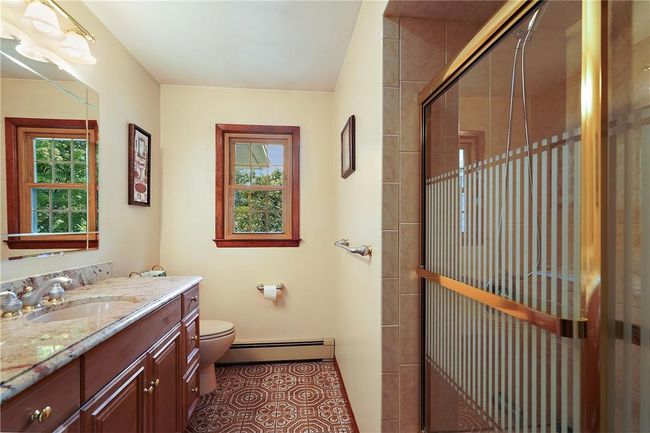 Bathroom with tile patterned flooring, a baseboard heating unit, toilet, and vanity | Image 19