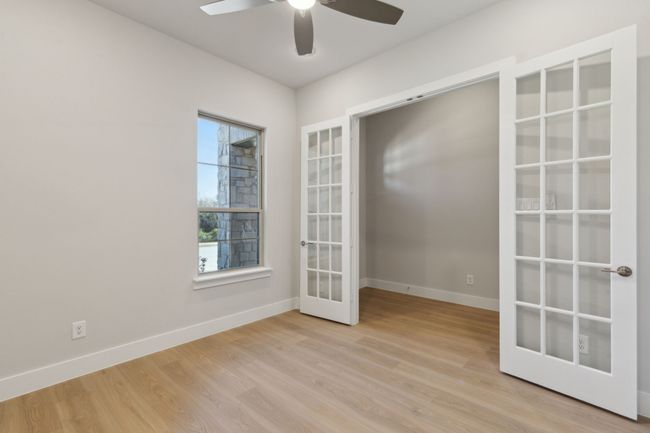 Spare room with french doors, light wood finished floors, and a ceiling fan | Image 8