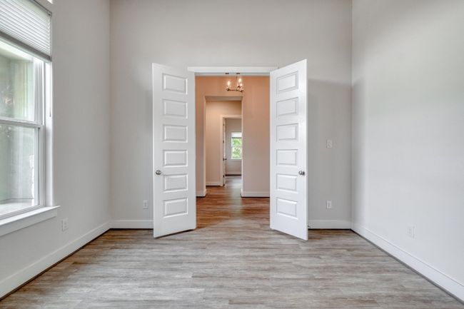 Spare room featuring a chandelier and light wood-type flooring | Image 15