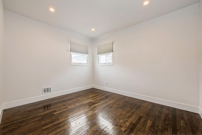 Unfurnished room with visible vents, baseboards, recessed lighting, and dark wood-style floors | Image 9