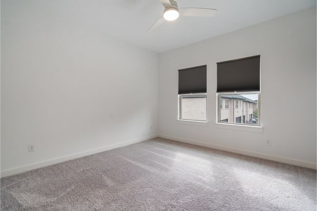 Carpeted spare room with ceiling fan and baseboards | Image 24