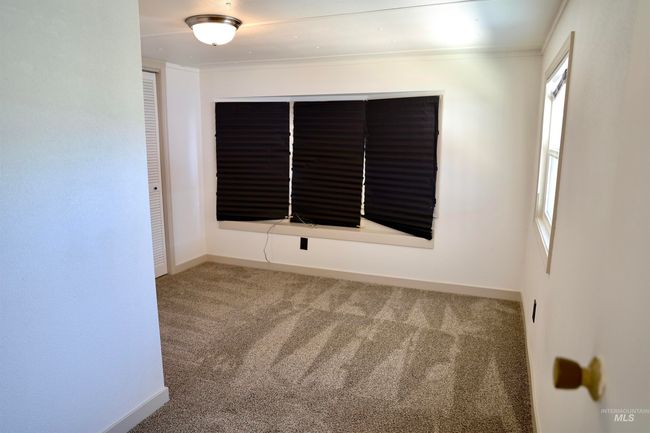 Carpeted empty room with baseboards | Image 16