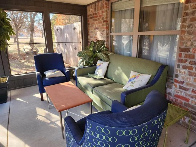 Sunroom with brick wall, plenty of natural light, and outdoor lounge area | Image 12