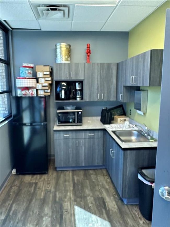 Kitchen featuring a paneled ceiling, refrigerator, gray cabinetry, dark wood-type flooring, and sink | Image 14