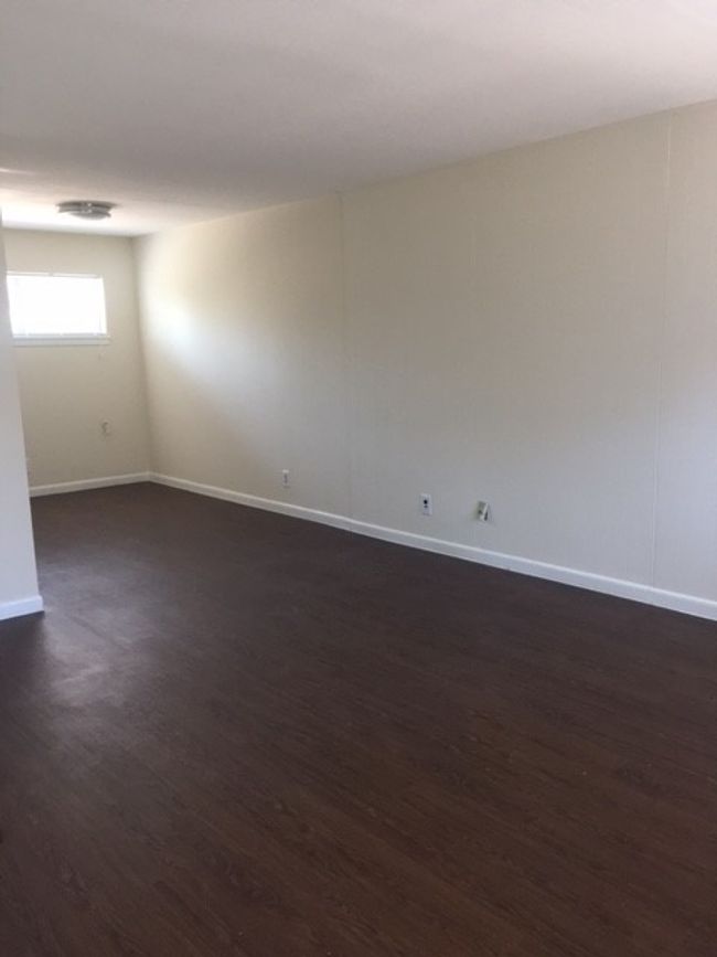 Unfurnished room featuring dark wood-style floors and baseboards | Image 19